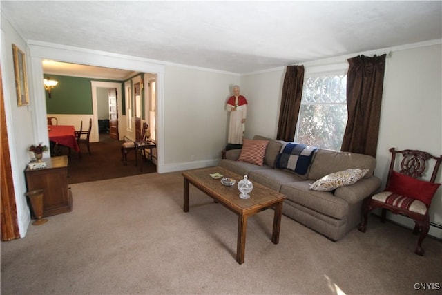 carpeted living room with crown molding and a chandelier