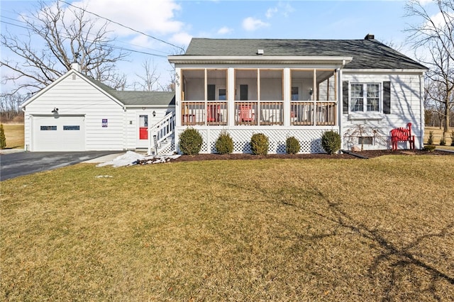 view of front facade featuring a sunroom, a front yard, a garage, and a porch