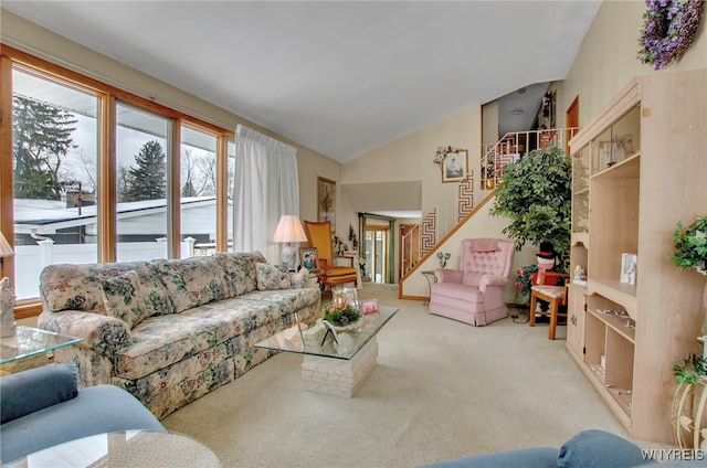 carpeted living room featuring lofted ceiling