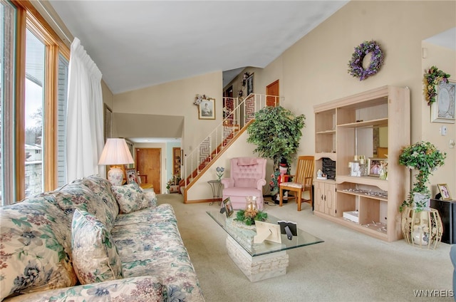 living room featuring vaulted ceiling and light carpet