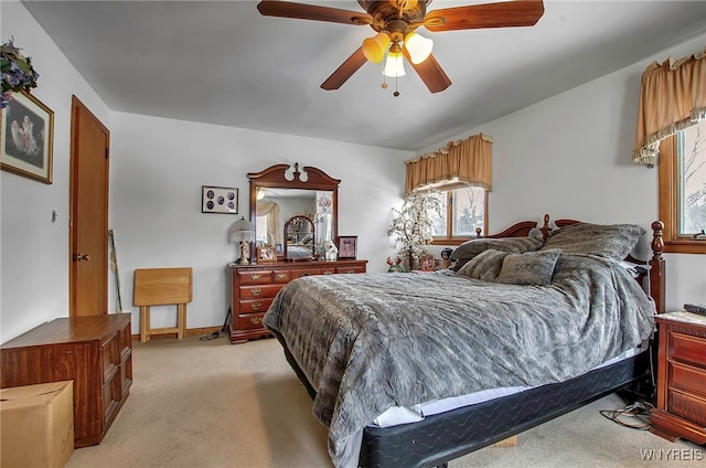 bedroom featuring ceiling fan and light carpet