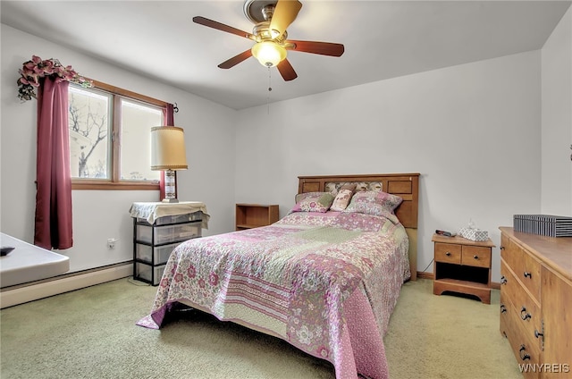 bedroom with a baseboard heating unit, light carpet, and ceiling fan