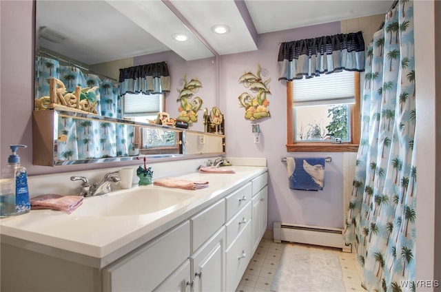 bathroom with vanity, curtained shower, and baseboard heating