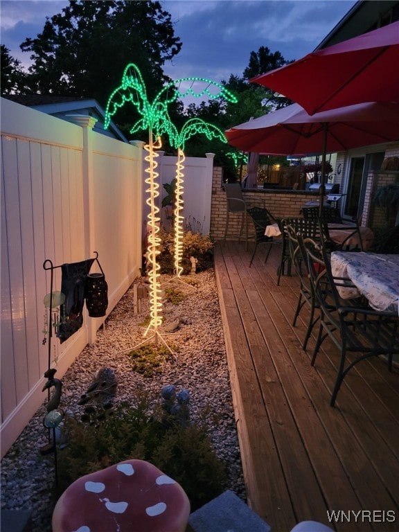 deck at dusk with an outdoor bar