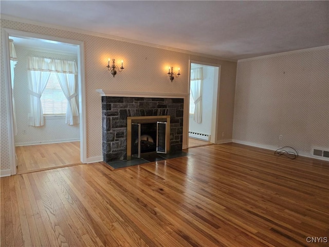 unfurnished living room featuring ornamental molding, a stone fireplace, wood-type flooring, and baseboard heating