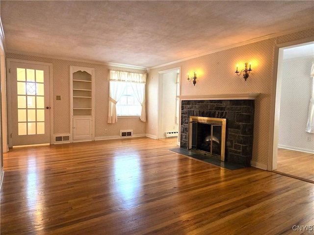 unfurnished living room featuring a fireplace, hardwood / wood-style flooring, ornamental molding, baseboard heating, and a textured ceiling