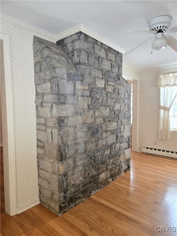 interior details with crown molding, ceiling fan, wood-type flooring, and baseboard heating