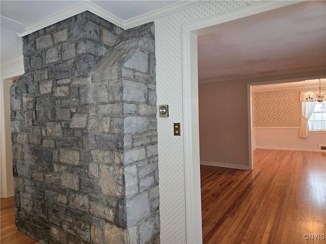 interior details featuring an inviting chandelier, wood-type flooring, and ornamental molding