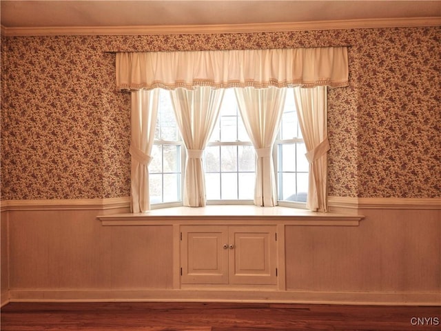 interior space with hardwood / wood-style floors and ornamental molding