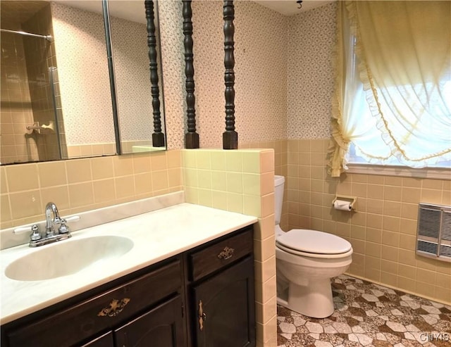 bathroom with vanity, tile walls, walk in shower, and toilet