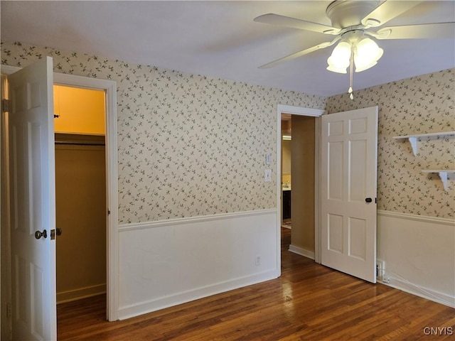 unfurnished bedroom featuring ceiling fan, dark hardwood / wood-style floors, and a closet