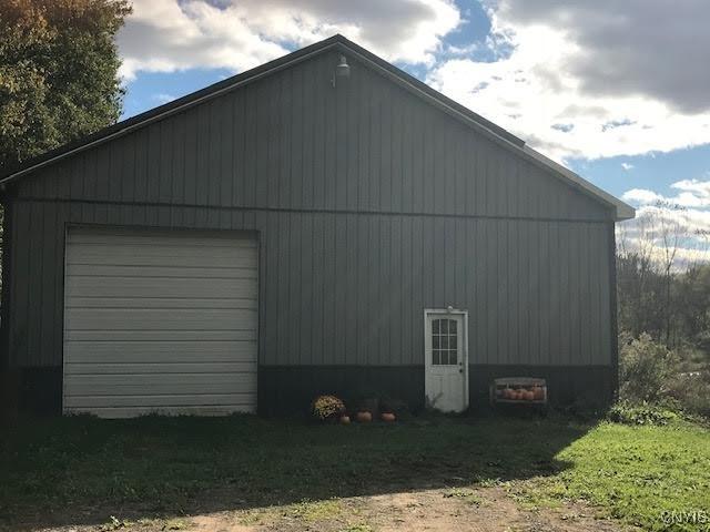 view of home's exterior featuring an outbuilding and a garage