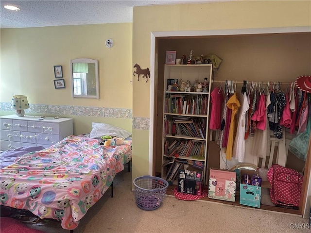 bedroom featuring a textured ceiling and carpet flooring