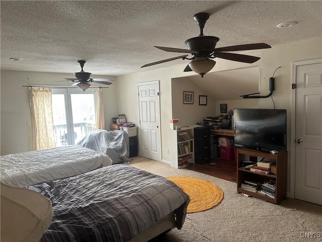 bedroom with ceiling fan, access to exterior, and a textured ceiling