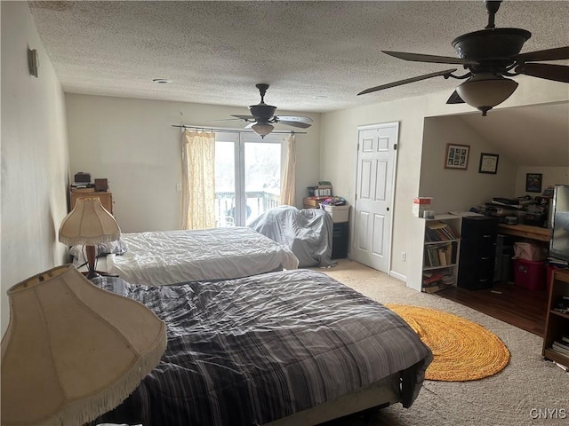 carpeted bedroom with a textured ceiling and ceiling fan