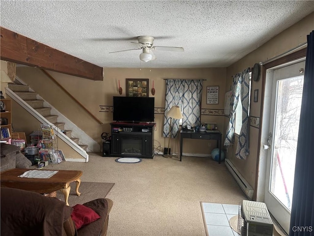 living room with baseboard heating, plenty of natural light, a textured ceiling, and ceiling fan