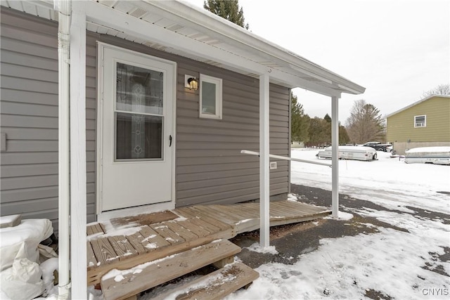 view of snow covered property entrance