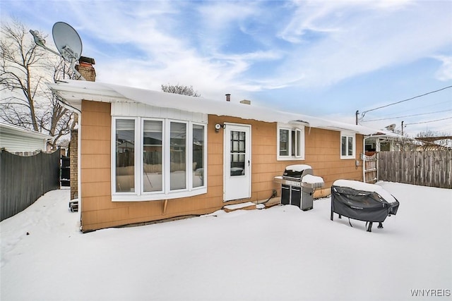 view of snow covered rear of property