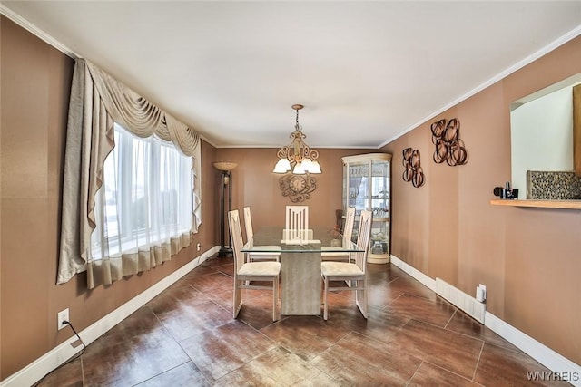 dining room with crown molding and a chandelier