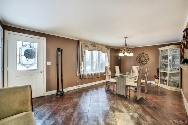 dining room with ornamental molding and a chandelier