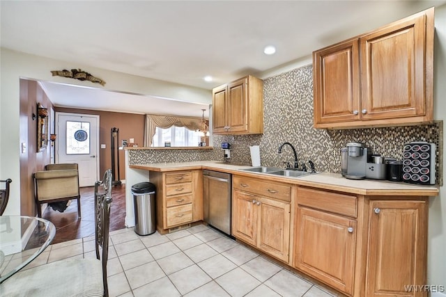 kitchen featuring sink, light tile patterned floors, stainless steel dishwasher, pendant lighting, and decorative backsplash