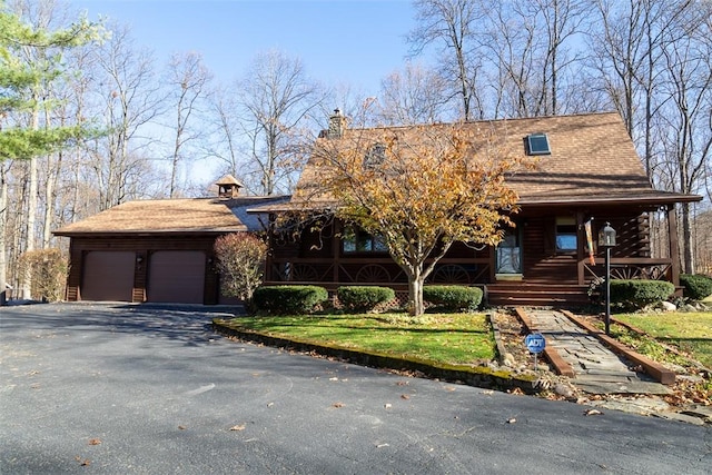 view of front of home with aphalt driveway and an attached garage