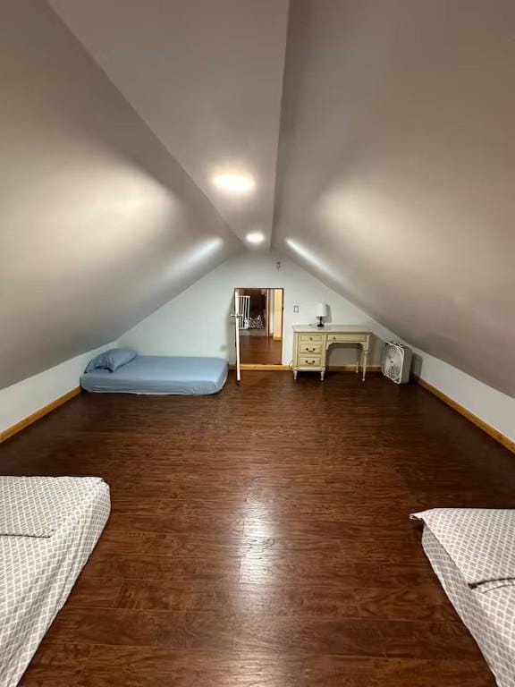 additional living space featuring dark hardwood / wood-style flooring and vaulted ceiling