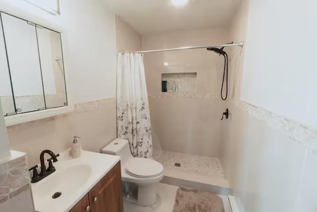 bathroom featuring vanity, toilet, and a shower with shower curtain