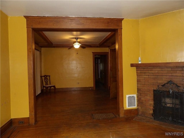 interior space with ceiling fan, dark hardwood / wood-style floors, and a fireplace