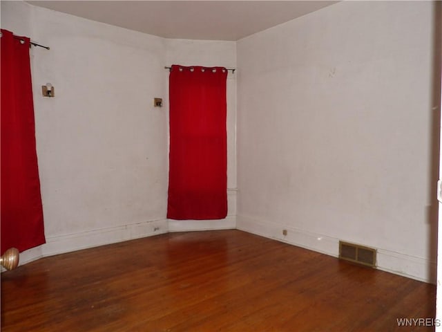 spare room with dark wood-type flooring