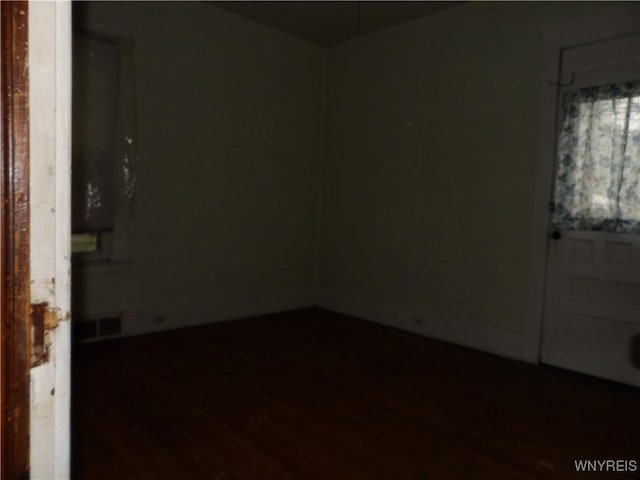 spare room with dark wood-type flooring