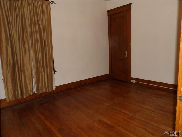 empty room featuring dark hardwood / wood-style flooring