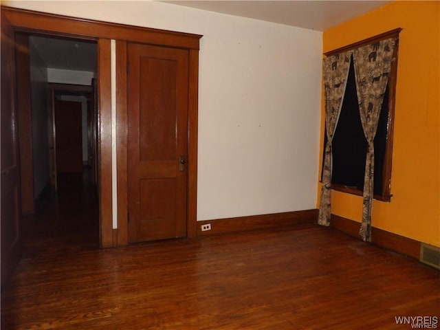 spare room featuring dark hardwood / wood-style flooring