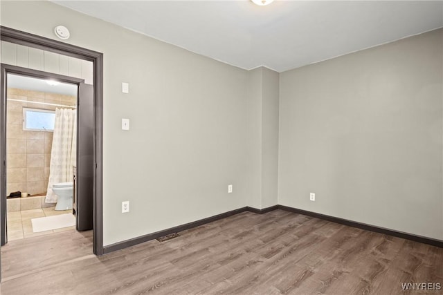 spare room with light wood-type flooring