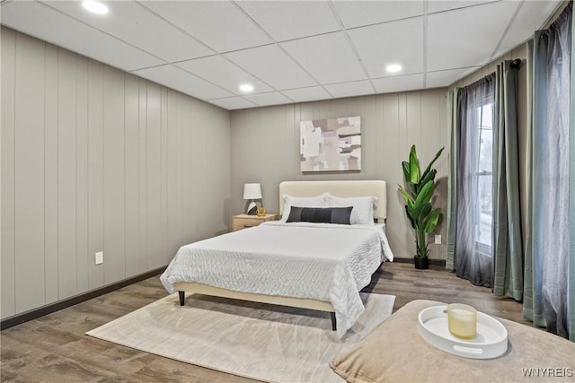 bedroom featuring a paneled ceiling and wood-type flooring