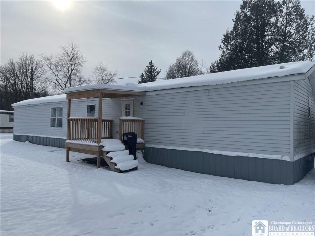 view of snow covered rear of property