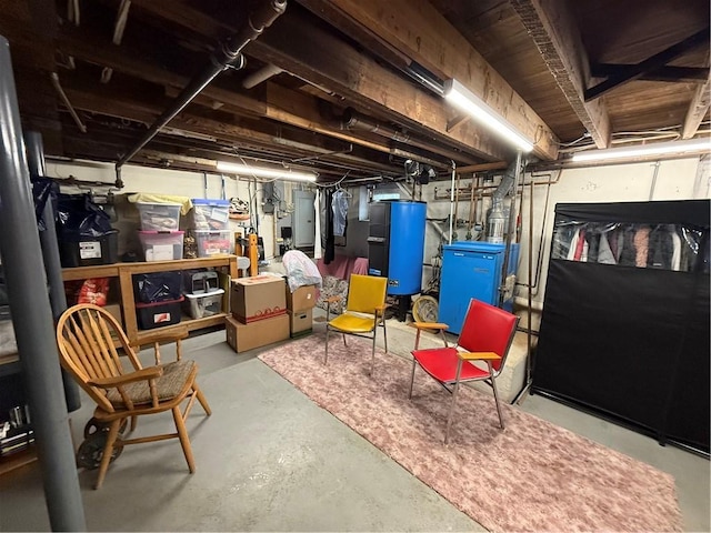 basement featuring electric panel and water heater