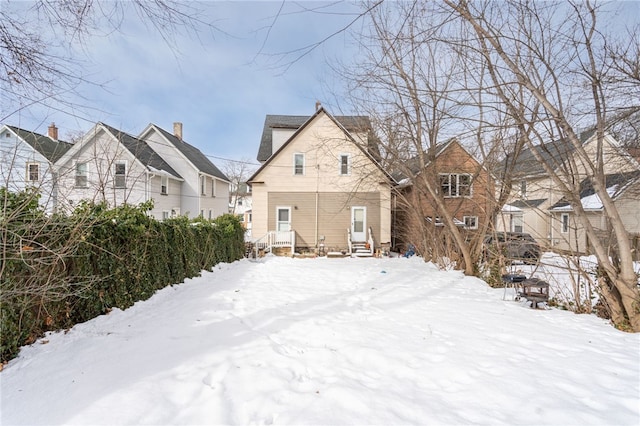 view of snow covered rear of property