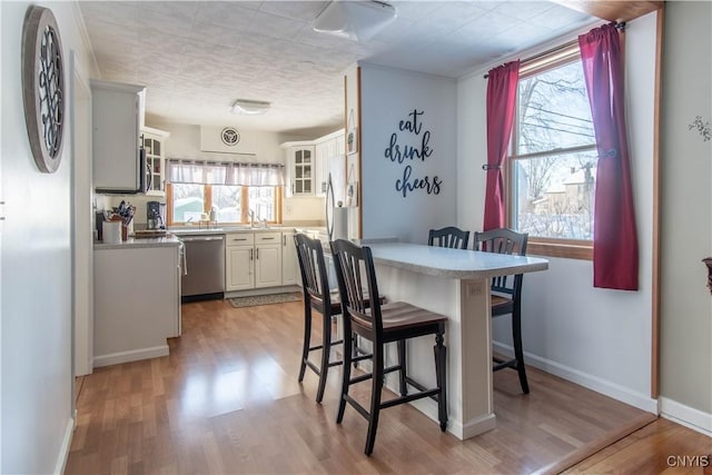 dining room with sink and light wood-type flooring