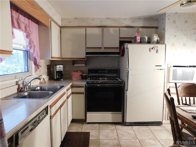 kitchen featuring white appliances, white cabinetry, sink, and light tile patterned floors