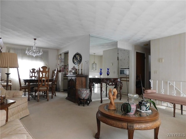 living room with an inviting chandelier and carpet flooring