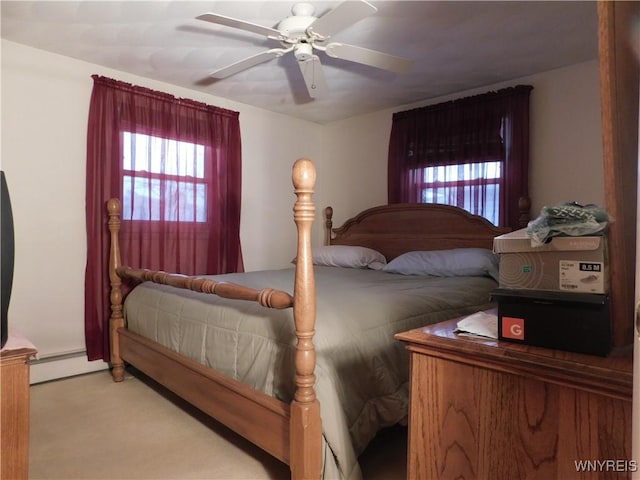 bedroom with ceiling fan, light colored carpet, and a baseboard radiator