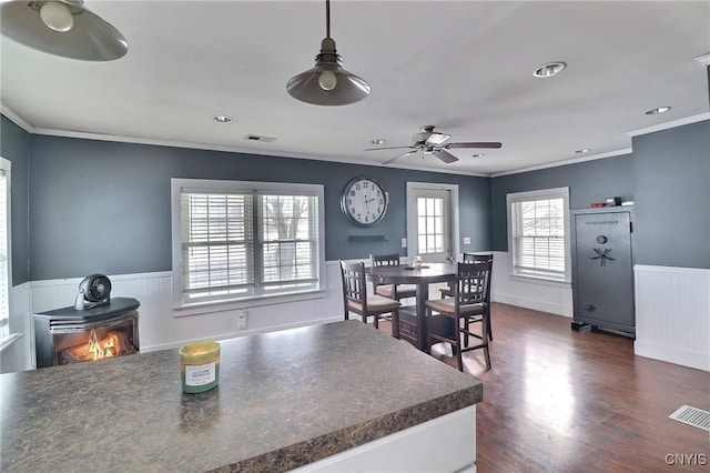 kitchen featuring ceiling fan, ornamental molding, and dark hardwood / wood-style flooring