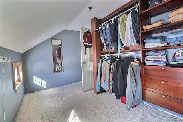 walk in closet featuring lofted ceiling and carpet floors