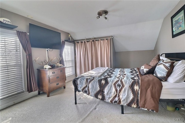 carpeted bedroom with vaulted ceiling