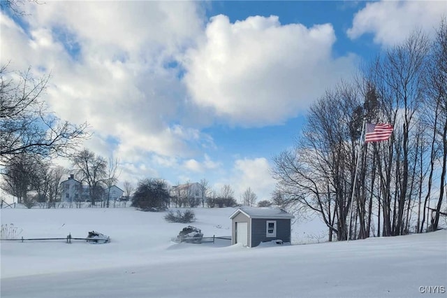 yard layered in snow featuring an outbuilding