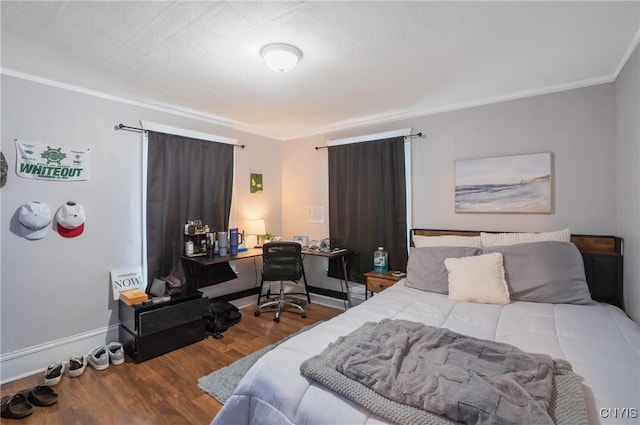 bedroom with hardwood / wood-style floors and crown molding