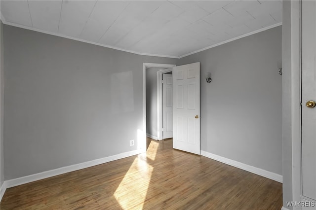 unfurnished bedroom featuring dark hardwood / wood-style flooring and ornamental molding