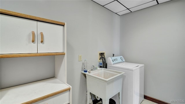 washroom with sink, cabinets, and washer / dryer