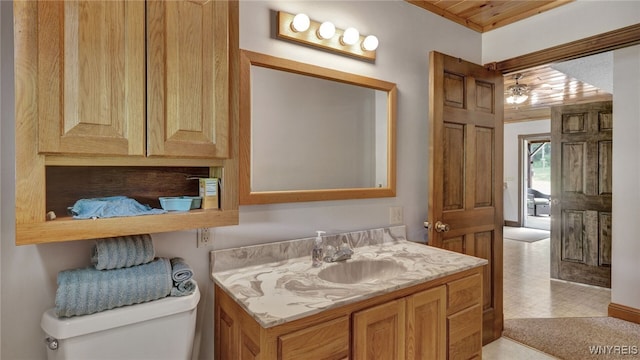 bathroom featuring vanity and toilet